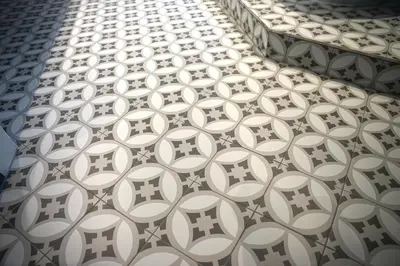 a row of white and black tiles on a wall at Alte Metzg - Boutique Pension in Appenzell
