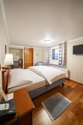 a large room with many tables and chairs at Hotel Säntis in Appenzell