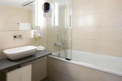 a bathroom with a sink and a tub and a shower at Hotel Löwen in Appenzell