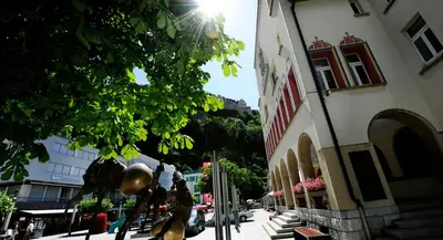 a city street with a building and a tree at b-smart motel Sevelen in Sevelen