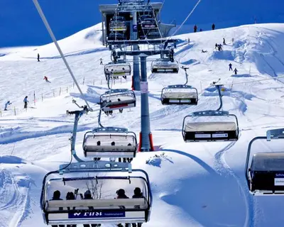 a group of people riding a ski lift in the snow at b-smart motel Sevelen in Sevelen