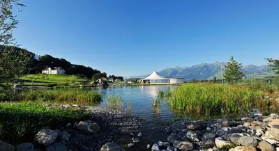 a river with a tent in the middle of a field at b-smart motel Sevelen in Sevelen