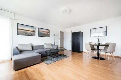 a living room with a couch and a table at SOHO 5A !Gratis Parken, Free Parking! in Kreuzlingen
