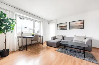 a living room with a couch and a table at SOHO 5A !Gratis Parken, Free Parking! in Kreuzlingen