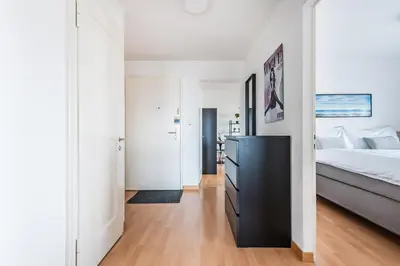 a bedroom with a large bed and a black dresser at SOHO 5A !Gratis Parken, Free Parking! in Kreuzlingen