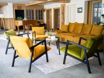 a living room with a couch and chairs and a table at Hotel Sternen Unterwasser in Unterwasser