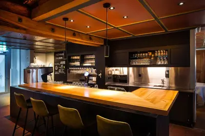 a bar with a wooden counter in a room at Gasthaus zum Trauben in Weinfelden