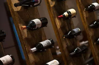 a bunch of wine bottles in a wooden door at Gasthaus zum Trauben in Weinfelden