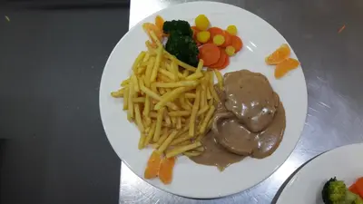 a white plate of food with pasta and vegetables at Gasthaus Gemsli in Nesslau