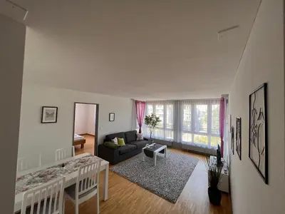 a living room with a couch and a table at Herisau Apartments in Herisau