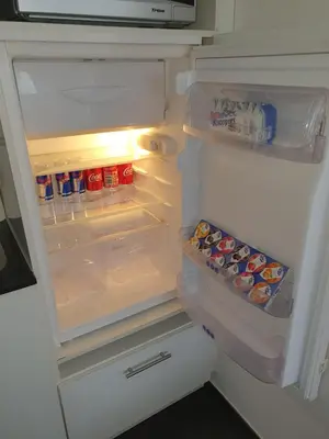 an open refrigerator with food and drinks in it at Schönes Studio in Arbon am Bodensee Neu Klimatisiert ! in Arbon