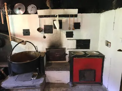 an old kitchen with a stove and a sink at Alphütte Burst in Alt Sankt Johann