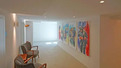 a hallway with chairs and paintings on the wall at Alte Metzg - Hostel in Appenzell