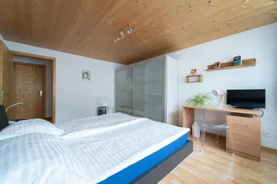 a bedroom with a large bed and a television at BNB Claudia in Appenzell