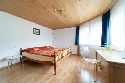 a bedroom with a bed and a wooden ceiling at BNB Claudia in Appenzell