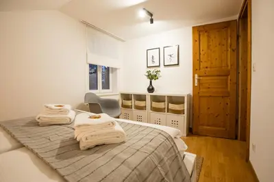 a bedroom with two beds with towels on them at INN JOY Apartments - Sankt Gallen West in St. Gallen