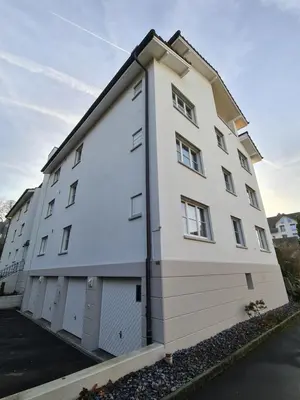 a large white building with two garage doors at HOME AWAY FROM HOME in Staad