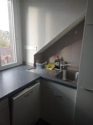 a kitchen with a sink and a counter top at Gemütliche Dachwohnung in St. Gallen