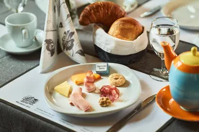 a plate of food on a table with bread at Gasthaus Hof in Appenzell