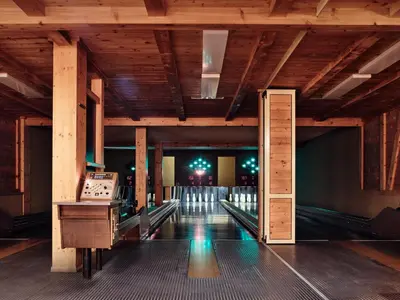 a bowling alley with a table and bowling lanes at Gasthaus Hof in Appenzell