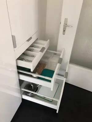 a white refrigerator with its door open in a room at INN JOY Apartments - Sankt Gallen Lachen in St. Gallen