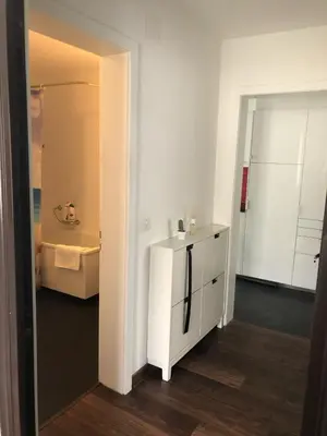 a kitchen with a white refrigerator in a room at INN JOY Apartments - Sankt Gallen Lachen in St. Gallen