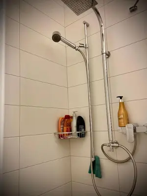 a shower with a shower head in a bathroom at Spielzimmer am Bodensee in Rorschach