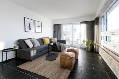 a living room with a couch and a large window at INN JOY Apartments - Rorschach mit Panoramasicht in Rorschach
