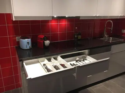 a kitchen counter with a sink with alot of utensils at INN JOY Apartments - Rorschach mit Panoramasicht in Rorschach