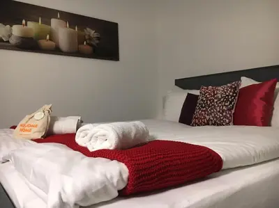 a bed with towels and pillows on it at INN JOY Apartments - Rorschach mit Panoramasicht in Rorschach