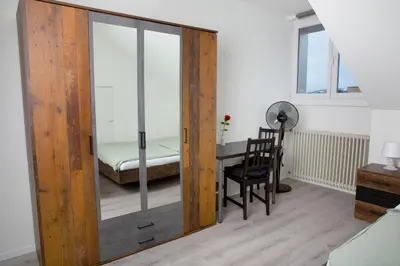 a room with a table and two chairs and a bed at RUSTICO INN - SIMPLE ROOMS -- OLMA Messen & Autobahn 1 Min, HSG 6 Min, Spital 7min, günstige Parkplätze in St. Gallen