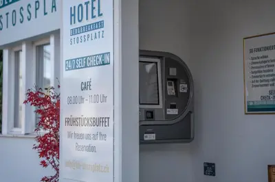 a room with a bedroom with a bed and a living room at Hotel B&B Stossplatz anytime and easy self Check-in in Appenzell