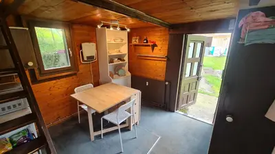 a small room with a table and a refrigerator at Grosses Ferienhaus für traumhafte Familienferien im Appenzellerland in Speicher