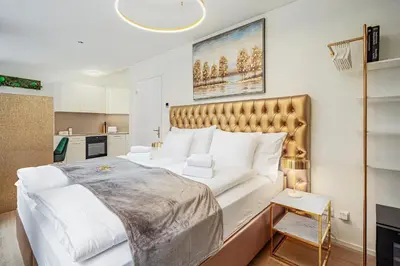 a bedroom with a large bed in a room at VISIMO Apartments Mühlensteg St Gallen - Elegant Quiet Central in St. Gallen