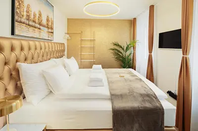 a bedroom with a large bed with white pillows at VISIMO Apartments Mühlensteg St Gallen - Elegant Quiet Central in St. Gallen