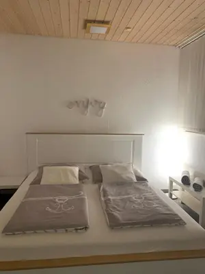 a bedroom with a large white bed in a room at Guest room David 11 in St. Gallen