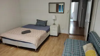 a small bedroom with a bed and a mirror at City Home St Gallen in St. Gallen