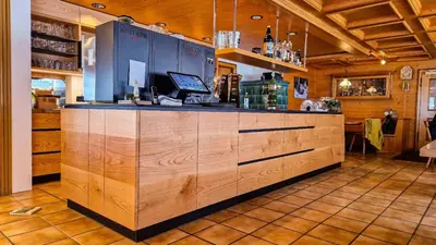 a kitchen with wooden cabinets and a counter top at Gasthaus Rössli in Brülisau