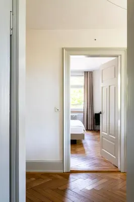 an open door leading to a bedroom with a bed at Militärkantine St. Gallen in St. Gallen