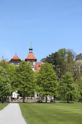 a park with trees and a building in the background at Militärkantine St. Gallen in St. Gallen