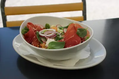 a bowl of salad on a plate on a table at Militärkantine St. Gallen in St. Gallen
