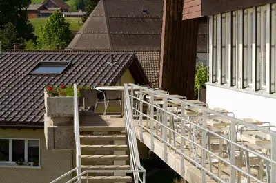 a stairway leading to a building with a balcony at Hotel Swiss Views in Hemberg