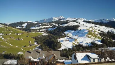 a town with snow on a mountain at Hotel Swiss Views in Hemberg