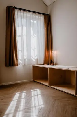 an empty room with a large window and a table at Hotel Müllers - Self-Check-in in Arbon