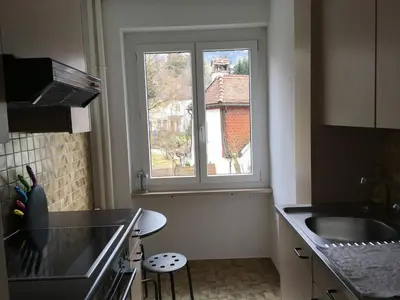 a kitchen with a sink and a window at 2 rooms with balcony, central, quiet location in St. Gallen
