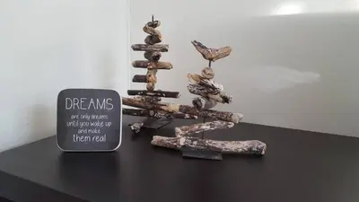 a metal sculpture of a tree on a table with a sign at Casa Schilling- 2,5 rooms with balcony near hospital, university in St. Gallen