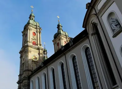 a building with a clock tower on top of it at Casa Schilling - 4 charming rooms in the best location in St. Gallen
