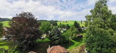 an aerial view of a small village in a green field at Camping Schönengrund in Schönengrund