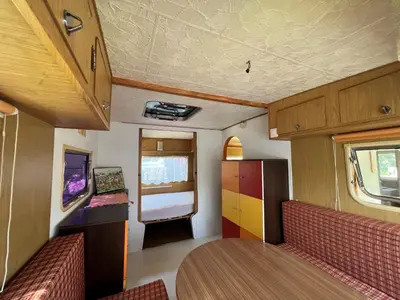 a small room with a table and chairs and a kitchen at Camping Schönengrund in Schönengrund