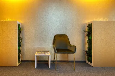 a chair and a table in a room at VISIMO Apartments Steigerstrasse St Gallen - Modern Living near OLMA & Hospital in St. Gallen
